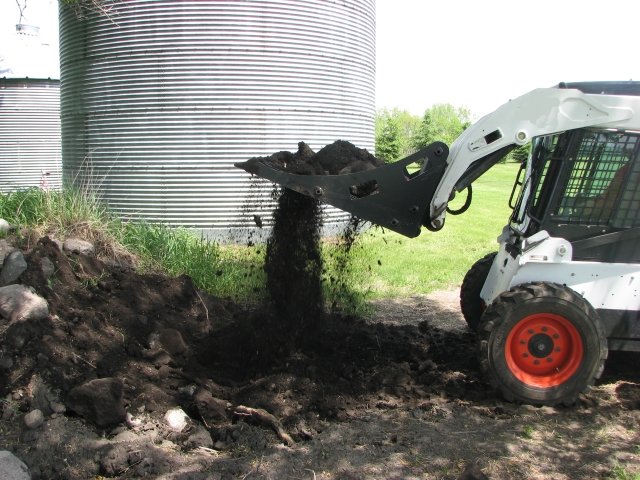 Rock Bucket picking up rocks.